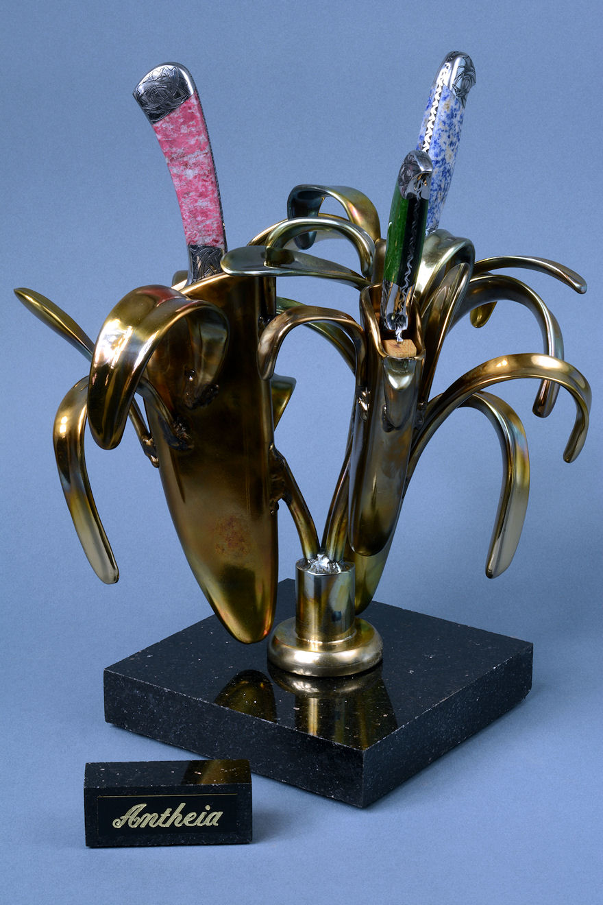 "Antheia" side view of hand-cast bronze sculpture with trio of knives with gemstone handles