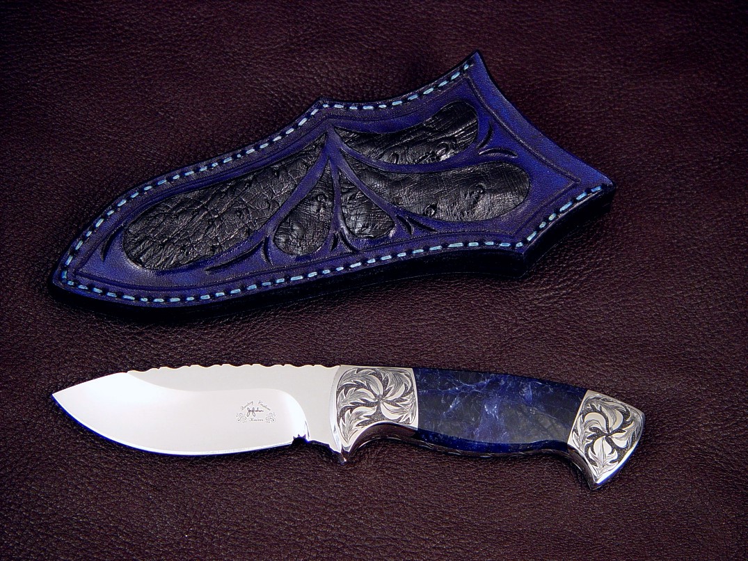 "Chama" obverse side view in 440C high chromium stainless steel blade, hand-engraved low carbon steel bolsters, black matrix sodalite gemstone handle, ostrich skin inlaid in hand-carved leather sheath