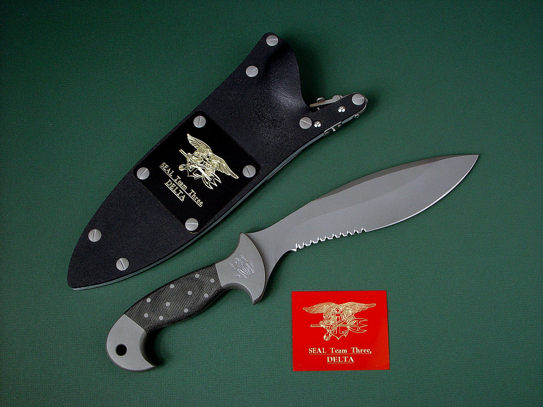 "Horus" obverse side view in ATS-34 high molydenum stainless steel blade, 304 stainless steel bolsters, engraved, Micarta phenolic handle, locking kydex, aluminum, stainless steel sheath with black lacquered brass engraved flashplate.