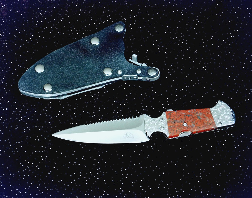 The "Kid" CSAR double edged knife with hookblade, obverse side view in 440C high chromium stianless steel blade, hand-engraved 304 stainless steel bolsters, brecciated jasper gemstone handle, locking kydex, aluminum, stainless steel sheath