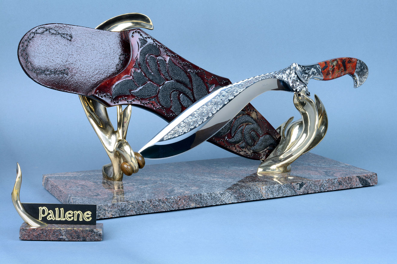 "Pallene" khukri, obverse side view in CPM154CM High molybdenum powder metal technology stainless tool steel blade, hand engraved, with hand-engraved 304 stainless steel bolsters, Brecciated Jasper gemstone  handle, hand-carved leather sheath inlaid with rayskin, hand-cast silicon bronze and Imbuya hardwood stand and Paradiso Classico Granite base