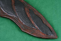 "Ananke" custom handmade khukri knife, sheath front detail. Sheath is meticulously constructed in artistic form, with long curved stitch lines in black polyester and large panel inlays of buffalo skin
