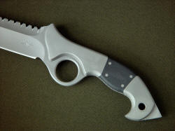 "Ari" obverse side handle detail. Knife is comfortable, solid, extremely well constructed for counter-terrorism use and durablity. Note rounded grind terminations, radiused forefinger ring