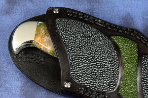 "Axia EL" fine handmade knife sheath mouth front detail  in T3 deep cryogenically treated CPM 154CM high mollybdenum powder metal technology martensitic stainless steel blade, 304 stainless steel bolsters, Linda Marie Moss Agate gemstone handle, hand-carved leather shoulder inlaid with green, black ray skin