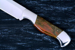 "Thresher" fine handmade chef's knife, BBQ knife, fillet knife, obverse side handle view in T3 cyrogenically treated 440C high chromium stainless steel blades, 304 stainless steel bolsters, Caprock petrified wood gemstone handles, Bison (American Buffalo), leather shoulder book case