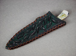 "Cygnus" chef's knife, kitchen knife, utility knife, sheathed view. Sheath is deep, thickly made and strong, hand-carved and tooled, hand-laced leather