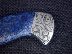 "Domovoi" obverse side rear bolster engraving detail. Four power enlargement shows hand-engraving in stainless steel, rich natural colors of blue gemstone handle