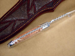"Kapteyn" knife spine edgework, filework detail. Sunrise pattern, fully tapered tang, dovetailed bolsters and gemstone