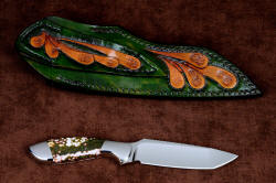 "Kita" reverse side view of knife and sheath back. Full hand-carving and tooling on sheath back and belt loop in heavy leather shoulder