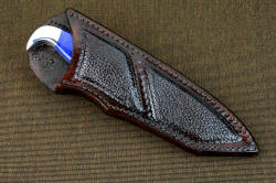 "Last Chance" sheathed view. Sheath has large panel inlays of buffalo skin, knife is deeply protected in tough and sealed sheath