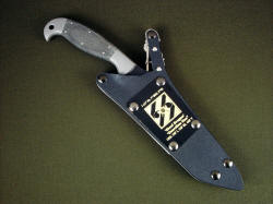 "Mercator" PEW combat knife, sheathed view. Sheath is positively locking with all stainess steel mechanism, removable engraved flashplate honoring service.