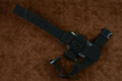 "Oculi" professional counterterrorism, tactical, working knife, shown with sheath mounted on EXBLX, back side view illustrating 2" wide leg strap and acetyl buckles