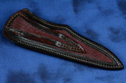 "Phact" fine handmade knife, sheath back view. Sheath is clean and even , with nylon stitching in medium brown heavy leather shoulder