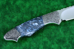 "Thuban" fine custom handmade knife, reverse side view in 3 power enlargement. The fit on this knife is exemplary, the high detail of the engraving in stainless steel accentuates the intricate handle patterns