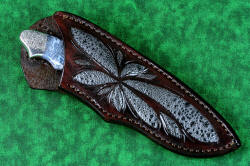 "Thuban" fine custom handmade knife, sheathed view. Sheath is high-backed, deep and protective, design complements the gemstone handle and engraving with inlays of frog skin