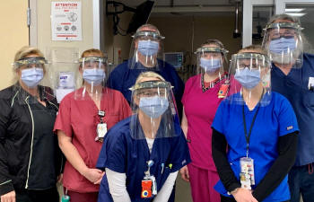 Emergency room staff with face shields