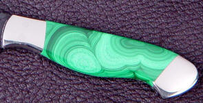 Malachite occurs in a stalactitic formation, and is a copper carbonate with intense green botryoidal patterns.