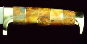 Petrified wood gemstone on hidden tang knife handle with brass fittings