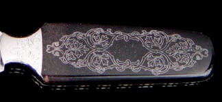 Black Petrified palm wood engraved with a diamond stylus cuts white