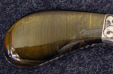 Blue tiger eye quartz on this full tang knife polishes brightly and is durable and tough