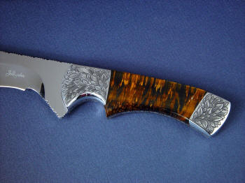 "Golden Eagle" obverse side view in CPM154CM high molybdenum powder metal technology tool steeel blade, hand-engraved 304 stainless steel bolsters, Bicolored Tiger Eye gemstone handle, Caiman skin inlaid in hand-carved leather sheath