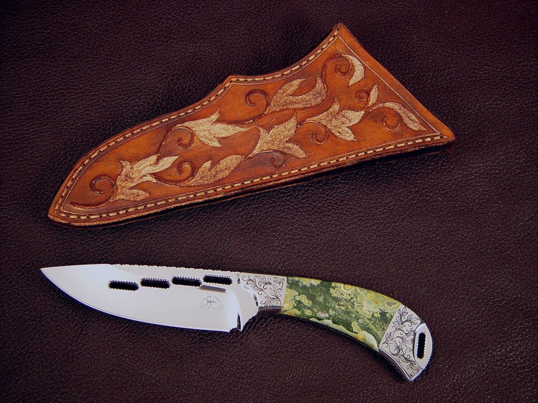 "Bootes" obverse side view in milled and mirror polished 440C high chromium stainless steel blade, hand-engraved 304 stainless steel bolsters, Rain Forest Jasper gemstone handle, hand-carved and bronzed leather sheath