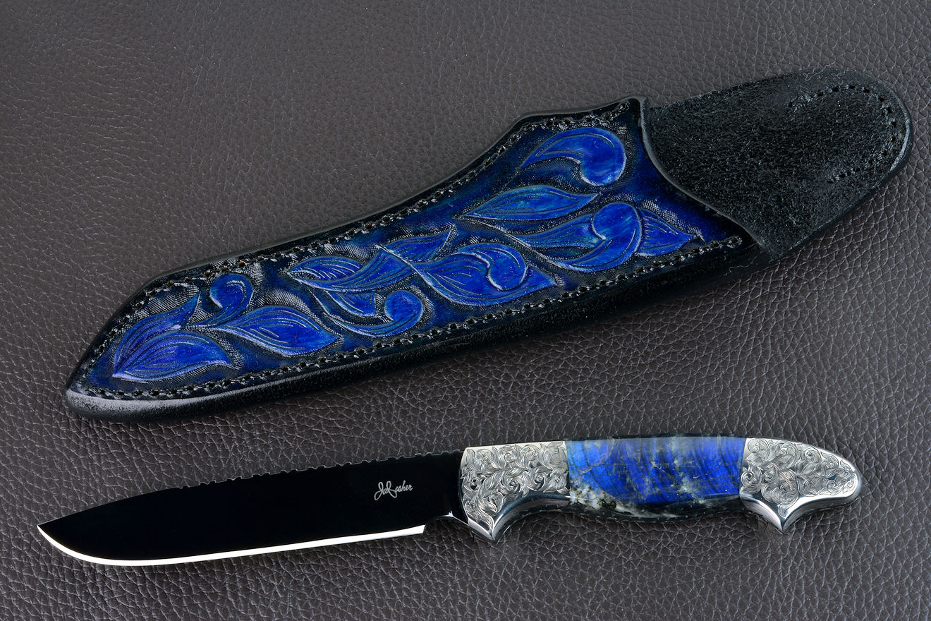 "Carina" obverse side view in mirror polished and hot-blued O1 high carbon tungsten-vanadium tool steel blade, hand-engraved 304 stainless steel bolsters, Labradorite gemstone handle, hand-carved, hand-dyed leather sheath