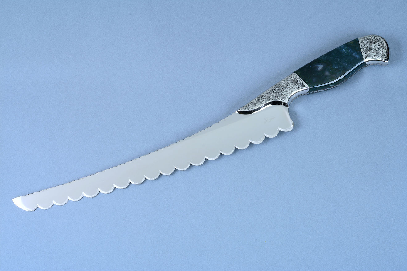 "Caph" (Cassiopeia chef's set) Bread, Serrated knife, obverse side view  in T3 cryogenically treated 440C high chromium stainless steel blade, hand-engraved 304 stainless steel bolsters, Indian Green Moss Agate gemstone handle