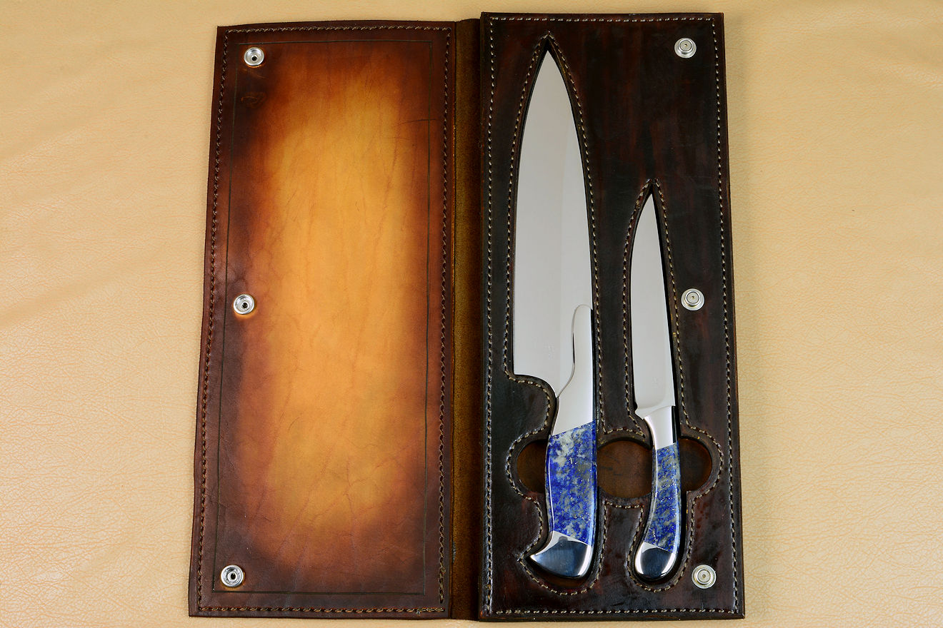 Open Book Case view of Concordia and Sanchez Custom Chef's Knives in T3 cryogenically treated 440C high chromium stainless steel blades, 304 stainless steel bolsters, Lapis Lazuli gemstone handles, book case in top grain leather, leather shoulder and belly, hand-carved, stainless steel snaps