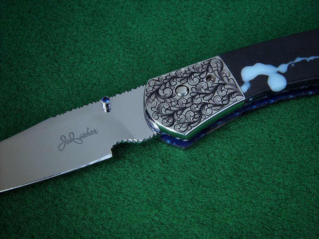 "Gemini" Liner Lock Folding Knife, obverse side view in 440C high chromium stainless steel blade, hand-engraved 304 stainless steel bolsters, anodized titanium liners, sapphire set thumb studs, case of Black Galaxy Granite gabbric anorothosite