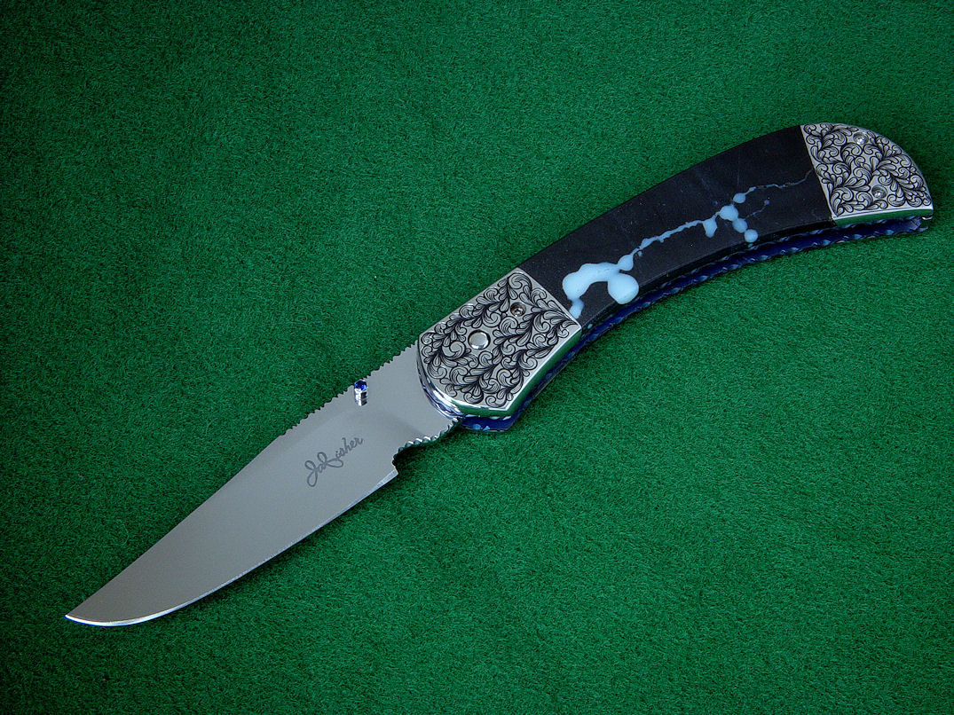 "Gemini" liner lock folding knife, obverse side view. Hollow ground blade is mirror polished 440C stainless steel, thumbnail stud is 304 stainless steel set with 2mm faceted blue sapphires