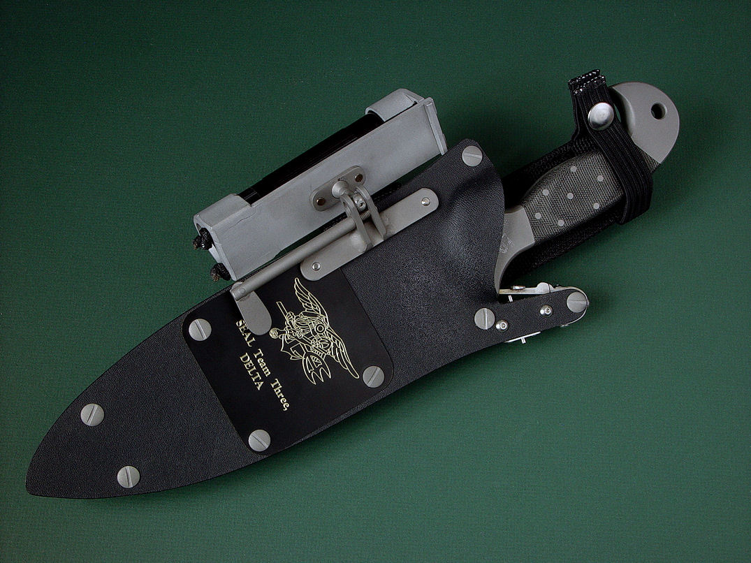 "Horus" obverse side view in ATS-34 high molydenum stainless steel blade, 304 stainless steel bolsters, engraved, Micarta phenolic handle, locking kydex, aluminum, stainless steel sheath with black lacquered brass engraved flashplate.