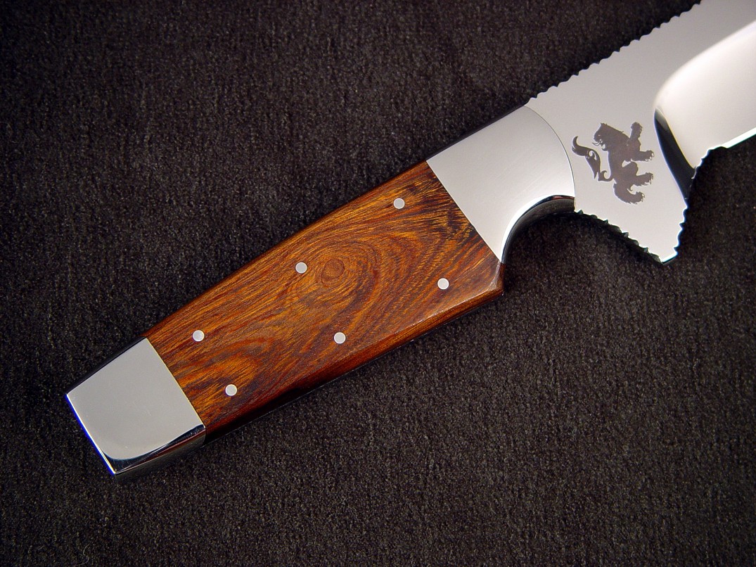 "Paraeagle" fine tactical knife in 440c high chromium stainless steel blade, custom etched, 304 stainless steel bolsters, Desert Ironwood handle, hand-carved and tooled leather sheath