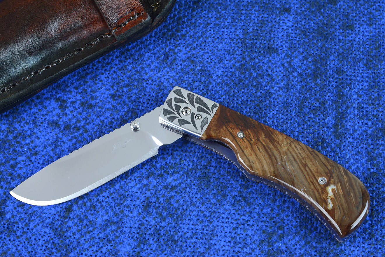 "Sadr" linerlock folding knife, obverse side view in 440c high chromium cryogenically treated stainless steel blade, hand-engraved 304 stainless steel bolsters, anodized 6AL4V titanium liners, Biggs Jasper Gemstone handle scales, leather pouch sheath with stainless steel snap