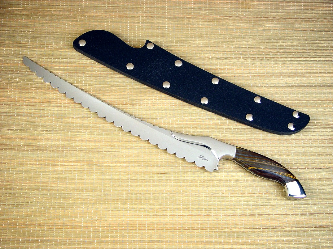 "Sasserides" Chef's bread knife, obverse side view in 440C high chromium stainless steel blade, 304 stainless steel bolsters, Australian Tiger Iron gemstone handle, kydex, nickel plated steel slip sheath