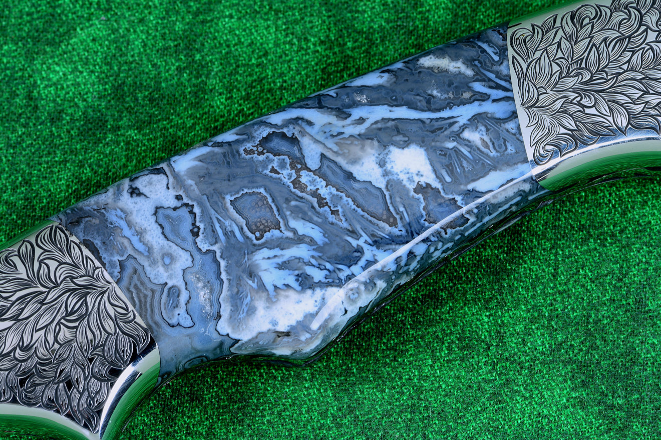 "Thuban" custom knife, obverse side view in CPM154CM powder metal technology, T3 cryogenically treated stainless steel blade, hand-engraved 304 stainless steel bolsters, Moss Agate gemstone handle, hand-carved leather sheath inlaid with frog skin