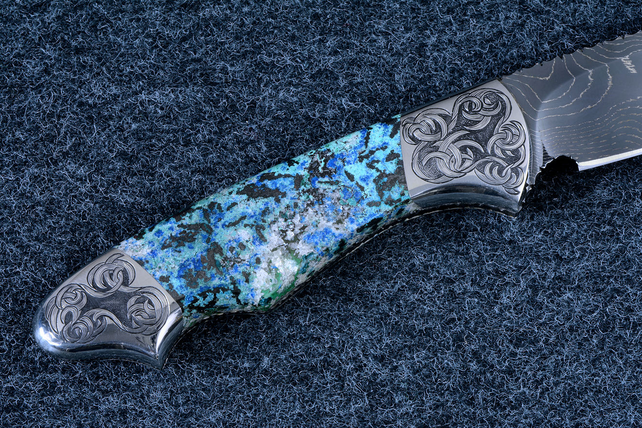 "Thuban" obverse side view in hot-blued 1095/nickel damascus blade, hand-engraved 304 stainless steel bolsters, Shattuckite gemstone handle, hand-carved, hand-dyed leather sheath