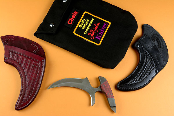"Chela" Karambit in 440C stainless steel blade, 304 stainless steel bolsters, black and red G10 handle, sheaths: tension and post lock in leather shoulder, stainless steel, nylon, envelope bag in lined ballistic nylon, polyester, stainless steel