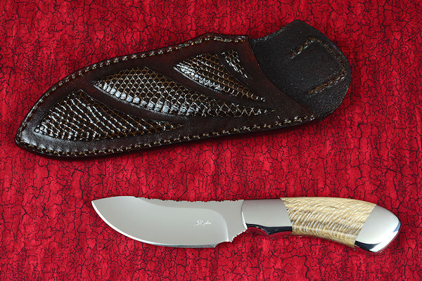 "Kochab" obverse side view in T3 deep cryogenically processed 440C high chromium martensitic stainless steel blade, 304 stainless steel bolsters, Petrified Sycamore Wood gemstone handle, sheath of lizard skin inlaid in hand-carved leather shoulder, nylon 