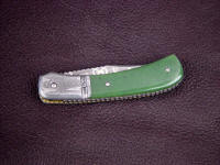 Pattern welded stainless steel damascus bolsters on folding knife with Jade gemstone handle