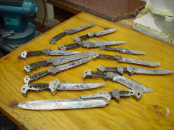 Multiple bolsters mounted on knives, peened solid.