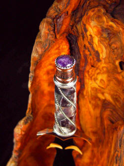 "Amethystine" dagger, pommel view. Solid Amythyst crystal caps the diffusion welded copper and nickel silver pommel
