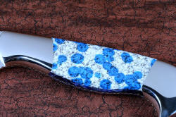 "Andromeda" obverse side gemstone handle detail view in T3 deep cryogenically treated CPM 154CM powder metal technology high molybdenum stainless steel blade, 304 stainless steel bolsters, K2 Azurite Granite gemstone handle, hand-carved leather sheath inlaid with blue rayskin