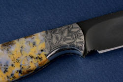 "Aquila" reverse side front bolster engraving detail. In this shot, you can clearly see the light grain in the blade formed while heat treating.