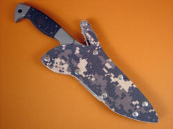 "Arabah" tactical, combat, survival knife, sheathed view. Sheath is postively locking, in desert pattern digital camouflage with all stainless steel components