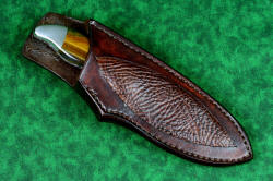 "Arcas" fine custom handmade knife, sheathed view. Sheath is a high-back design, knife sits deep and protected in heavy sealed leathers