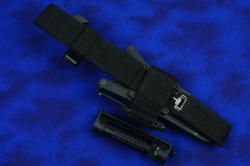 "Arctica" professional tactical, combat, rescue, counterterrorism knife, locking sheath mounted to UBLX, reverse side view showing sharpener pocket and ThruNite Ti3 flashlight mounting arrangement
