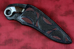 "Argiope" sheathed view, front, in ATS-34 high molybdenum stainless steel blade, T3 deep cryogenic treatment, 304 stainless steel bolsters, Spiderweb jasper gemstone handle, sheath of hand-carved leather inlaid with black and red rayskin