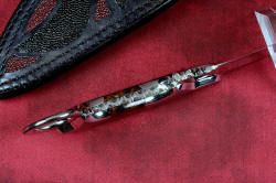 "Argiope" inside handle tang view in ATS-34 high molybdenum stainless steel blade, T3 deep cryogenic treatment, 304 stainless steel bolsters, Spiderweb jasper gemstone handle, sheath of hand-carved leather inlaid with black and red rayskin