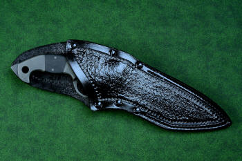 "Ari B'Lilah" Counterterrorism Tactical Knife, leather sheath view in T3 cryogenically treated CPM 154CM powder metal technology high molybdenum martensitic stainless steel blade, 304 stainless steel bolsters, Black G10 fiberglass/epoxy composite handle, hybrid tension tab-locking sheath in kydex, anodized aluminum, stainless steel, titanium
